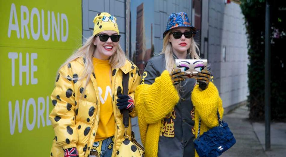 LONDON, ENGLAND - FEBRUARY 23: Fashion blogger Sam Beckerman wears Moschino jacket and hat, Sponge Bob bag, DIY by Panida jeans, gloves from London Market, Ray Ban sunglasses, Luxury Jones and Melrose sweater
