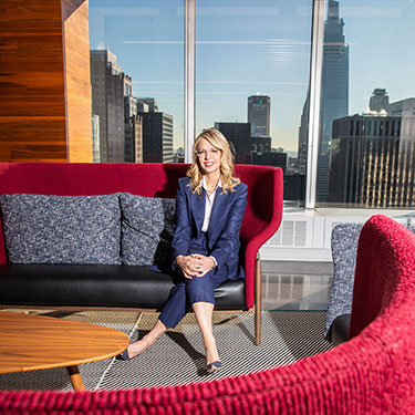 Pam Kaufman on a pink couch