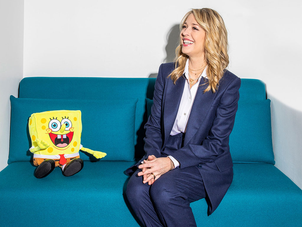 Pam Kaufman with SpongeBob Squarepants on a blue couch 