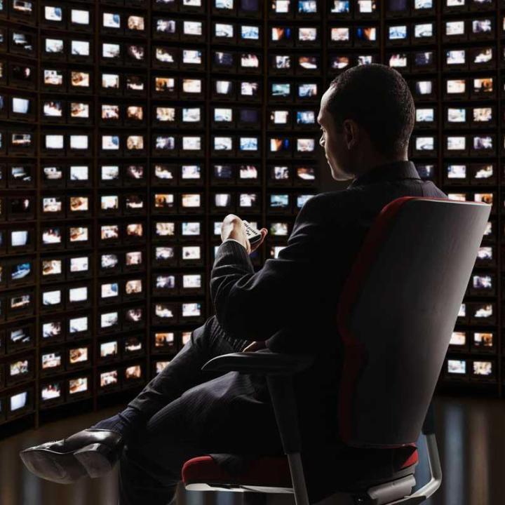 Man in a room full of screens