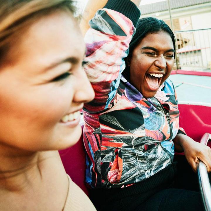 Two girls on a ride at a fair 