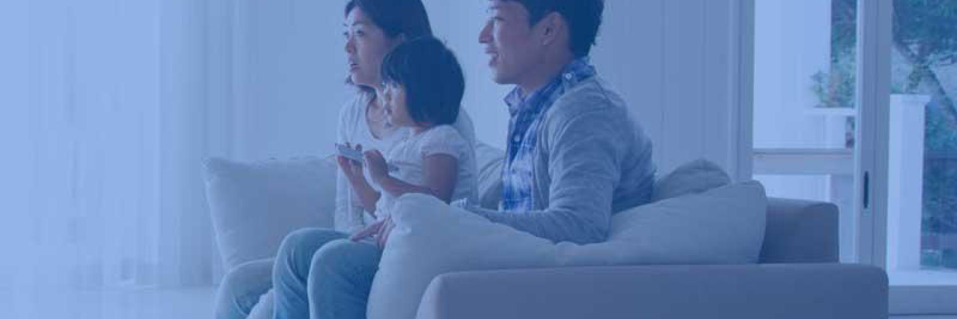 A family watching tv together  